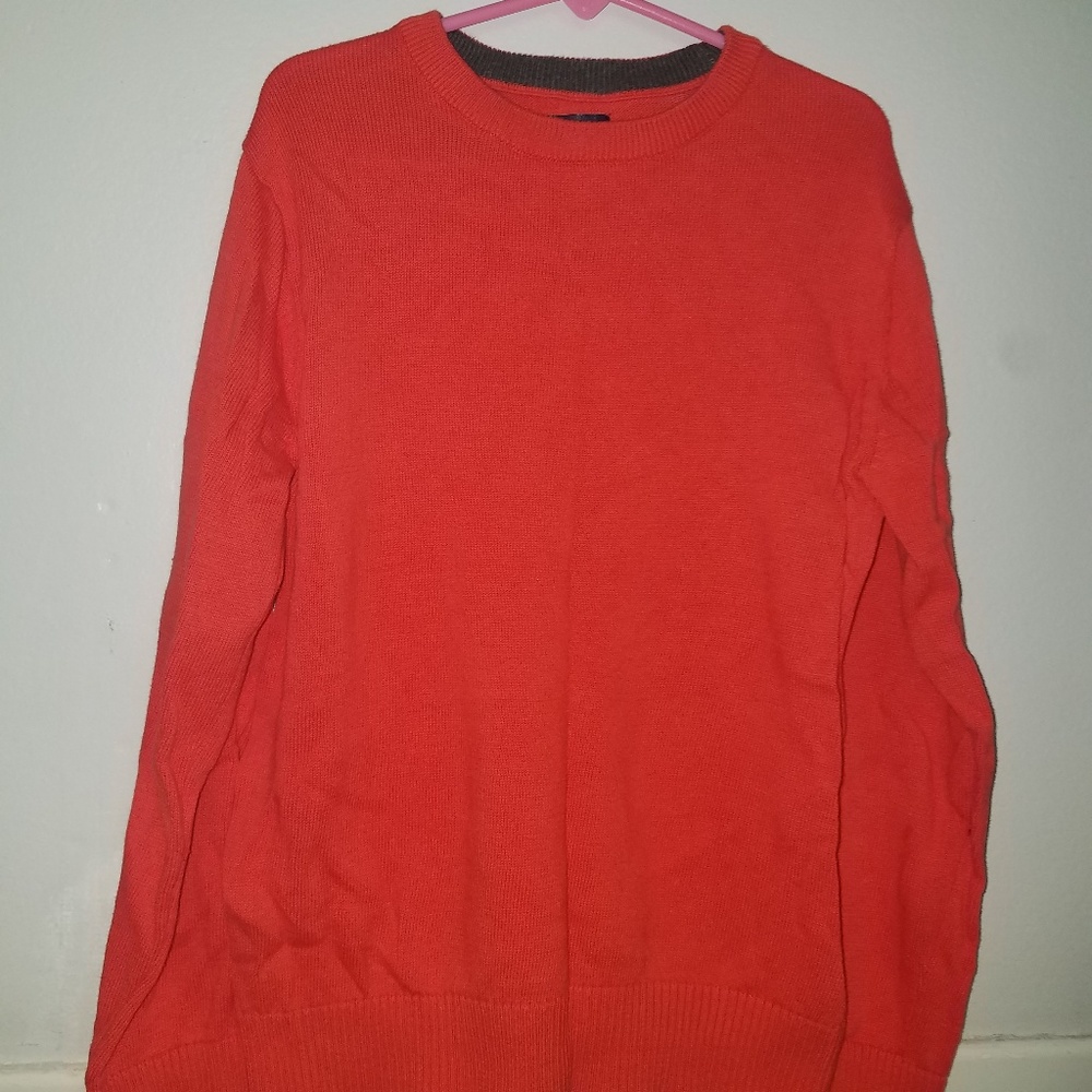 A boys orange/red sweater